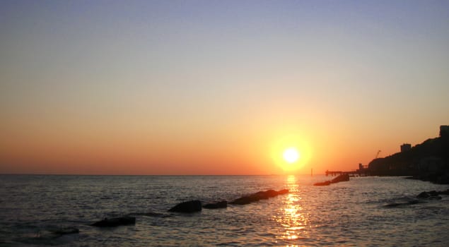 Sunset over summer sea with a small waves