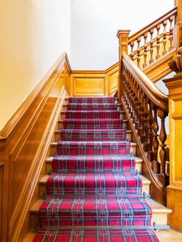 Stairs with carpet strip, old wooden staircase