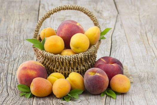 fresh fruits in a basket on wooden background