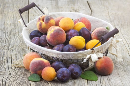fresh fruits in a basket on wooden background