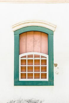 Decorative, colonial, green, vintage, window on a white wall in Paraty (or Parati), Brazil.