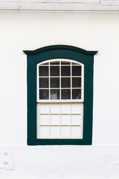 Decorative, colonial, vintage, window on a white wall in Paraty (or Parati), Brazil.