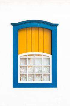 Decorative, colonial, blue, vintage, window on a white wall in Paraty (or Parati), Brazil.