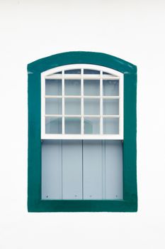 Decorative, colonial, green, vintage, window on a white wall in Paraty (or Parati), Brazil.