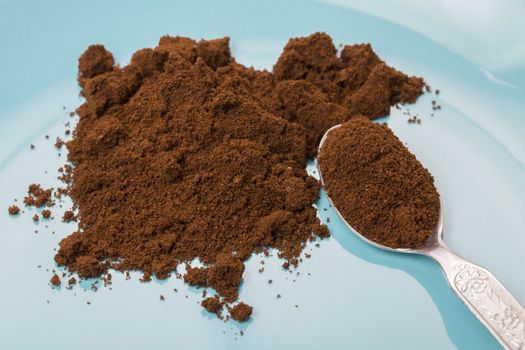 Picture of powder of coffee with metal spoon.