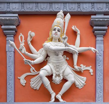Nataraj Dancing Form of Lord Shiva Hindu God Orange and White Statue on Temple Exterior Wall Relief