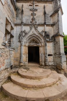 Main entrance door in renaissance style of the ruined castle of L��Herm in the french region of Dordogne