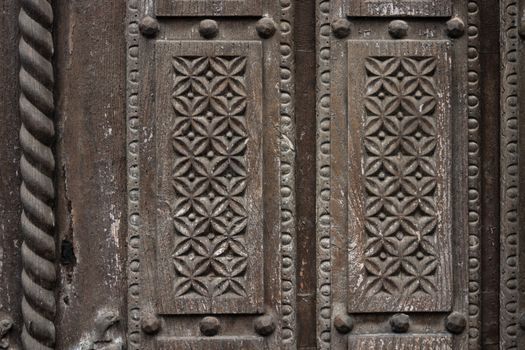Delicate wooden carving in a old door