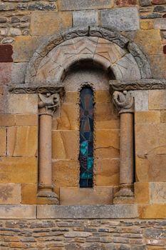 Delicate and beautiful romanesque window of the church of San Andres de Valdebarzana in Asturias Spain