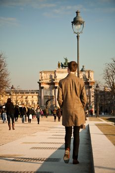 man walking in tuileries garden in Paris