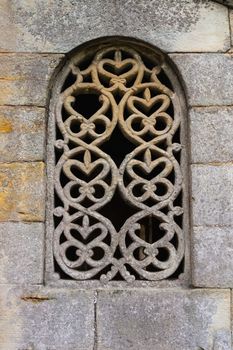 Stunning lattice window in the pre-romanesque church of San Salvador de Valdedios circa IX century in Asturias