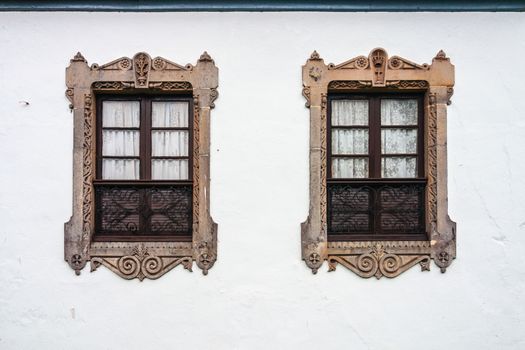Two beautiful decorated windows in a wall of the Salina Palace in Salamanca Spain