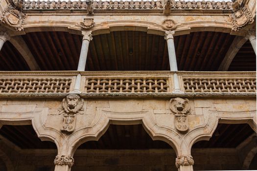 Beautiful stone archs and balcony delicate carving in the House of Shells in the city of Salamanca Spain
