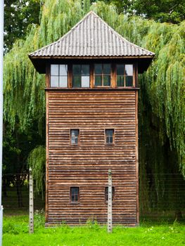 Wooden guard tower behind the fence of prison