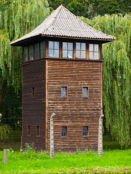 Wooden guard tower behind the fence of prison