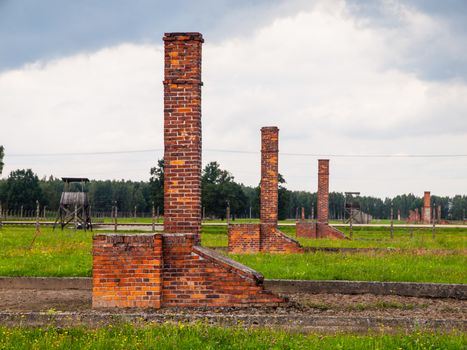 Brick chimneys left in ruins of accomodation buildings in Birkenau concentration camp (Poland)