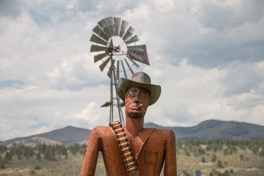 A metal statue of a gunslinger in Masonville, CO