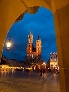 St. Mary's Church with two different towers by night (Krakow, Poland). Viewed from Sukiennice.