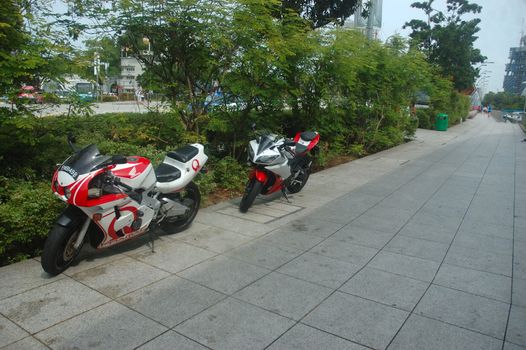 Singapore, Singapore - January 18, 2014: Honda motorcycle parked beside garden.