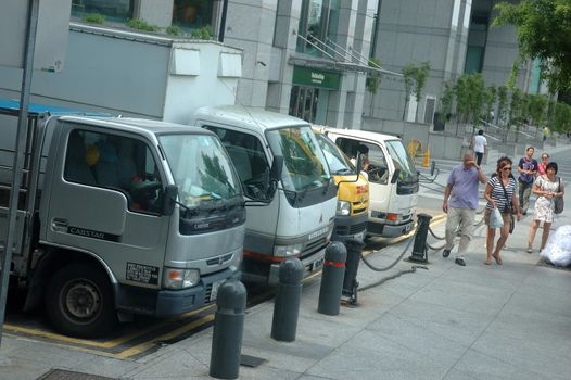 Singapore, Singapore - January 18, 2014: Trucks parked at Clarke Quay riverside, Singapore.