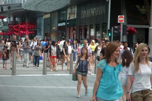 Singapore, Singapore - January 18, 2014: People crowd at Orchard road Singapore.