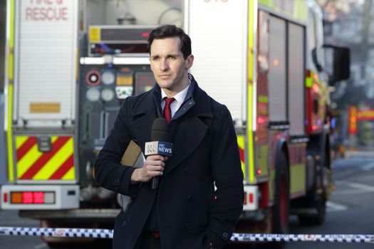 ROZELLE, AUSTRALIA - SEPTEMBER 4, 2014; ABC News Reporter at the scene covering the tragic incident Rozelle after a suspicious shop explosion claimed the lives of three people and inured others. Incident has closed the main road for over three days.