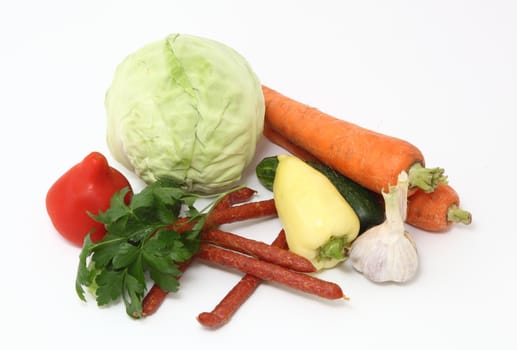 sausage and vegetables. Isolated on white background