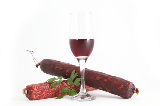 sausage and parsley with a glass of wine on a white background