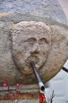 stone fountain with a face that spits water, dating back to medieval times 







stone fountain with face of medieval origin