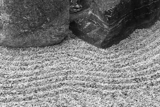 Classic rock feature accents a Zen garden in America.  Location is Tucson Botanical Gardens' Japanese Garden in Arizona.  Raked sand adds further traditional element.  