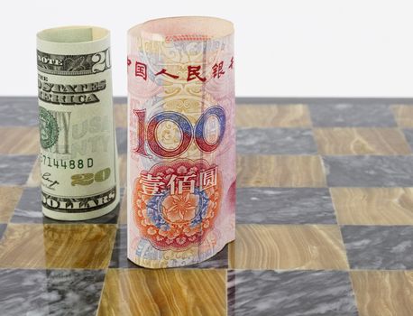 Rolled currency from USA and China placed upright on black and brown game board; 