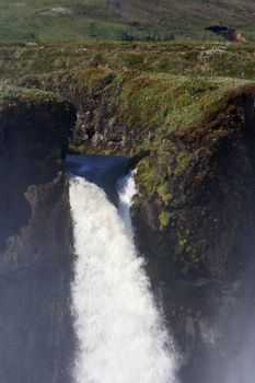 Section of roaring Godafoss, Iceland's spectacular waterfall located right on its main Ring Road; vertical image with copy space; 