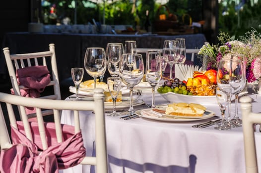 Decorated banquet table with food and tableware 