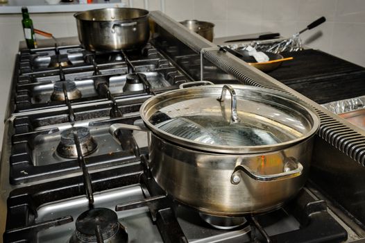 real dirty restaurant kitchen, pot on stove