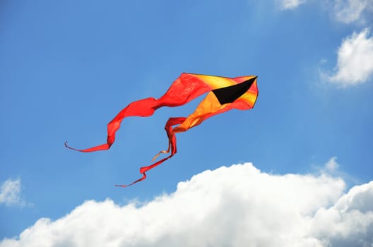 Yellow and orange kite flying