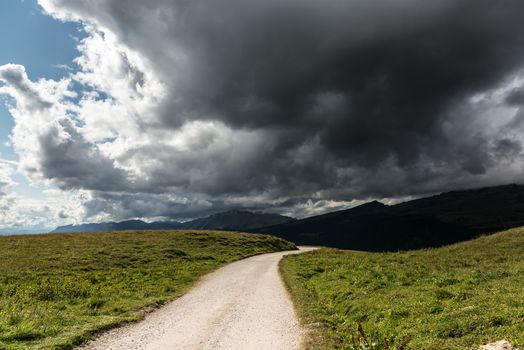 storm cloud over the mountain trail in the dolomites, Italy