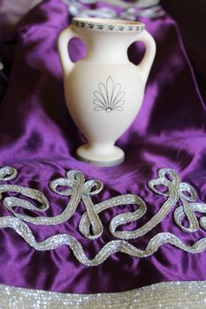 beautiful Moroccan pattern on the fabric and white amphora