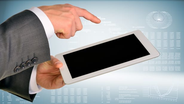 Businessman hand using tablet computer. Hi-tech background with graphs and figures