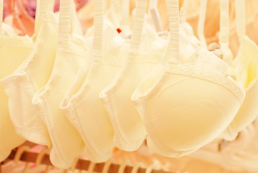 white bras row hanging in underwear store