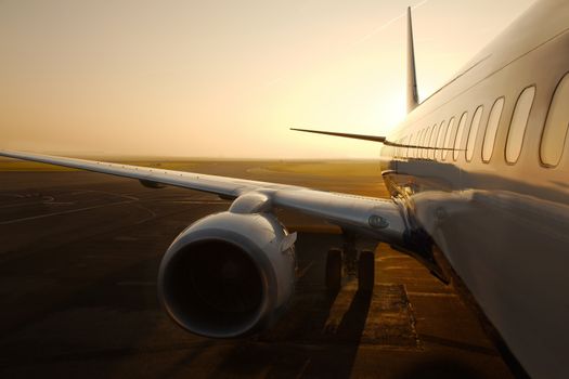 Airplane at an airport at sunrise