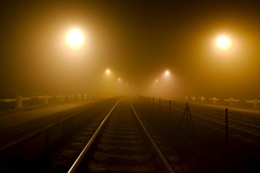 Rails in the fog at night