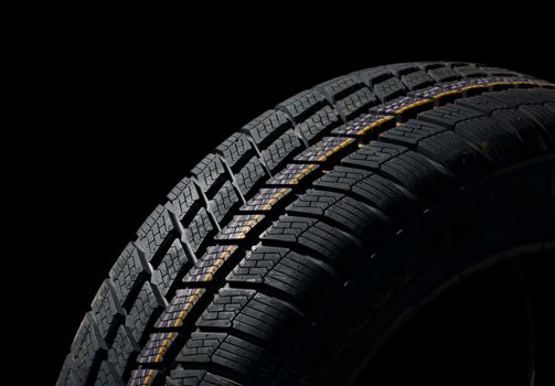 Winter tyre closeup, dark backgroud