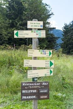 COL DE VOZA, FRANCE - AUGUST 24: Tour du Mont Blanc direction signs. The popular tour goes through France, Italy and Switzerland, and is clearly signalised throughout. August 24, 2014 in Col de Voza.