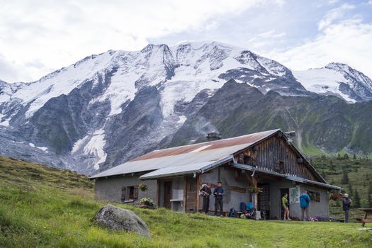 ST-GERVAIS-LES-BAINS, FRANCE - AUGUST 25: Hikers at the Truc Hostel, at bottom of the Domes de Miage mountain. This is one of the stages of the Mont Blanc Tour August 25, 2014 in St-Gervais-les-Bains.