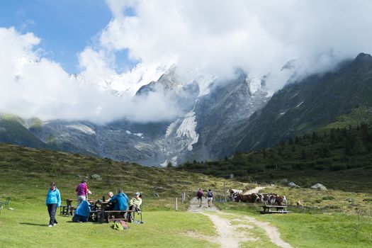 ST-GERVAIS-LES-BAINS, FRANCE - AUGUST 24: Hikers at the Truc Hostel, at bottom of the Domes de Miage mountain. This is one of the stages of the Mont Blanc Tour August 24, 2014 in St-Gervais-les-Bains.