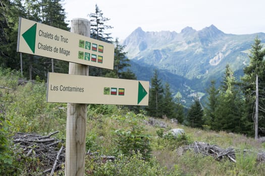 LES CONTAMINES, FRANCE - AUGUST 25: Tour du Mont Blanc direction signs. The popular tour goes through France, Italy and Switzerland, and is clearly signalised throughout. August 25, 2014 in Les Contamines.