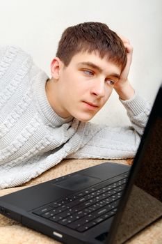 Teenager with Laptop on the Sofa