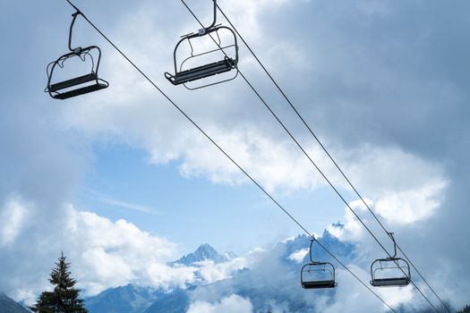 Low angle shot of alpine air lift with trees in the background