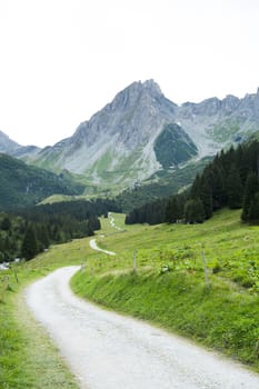French countryside road with Pennaz Needles in the background