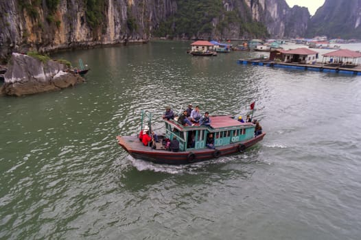 Tug in Fishing Village.  Ha Long Bay, Vietnam. EDITORIAL